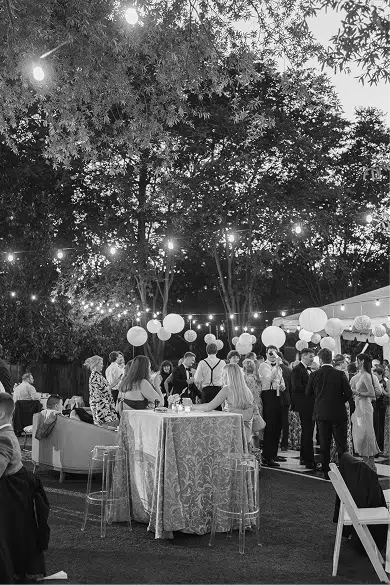 Outdoor wedding reception with guests mingling